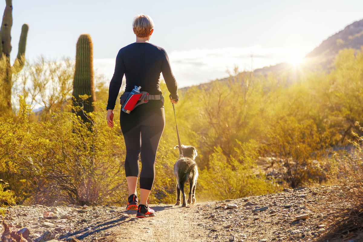 woman hiking with dog